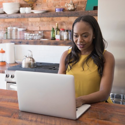 Businesswoman working on her laptop from home